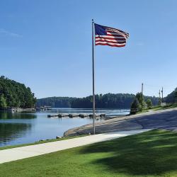 Scenic lakeside view featuring an American flag in Lake park